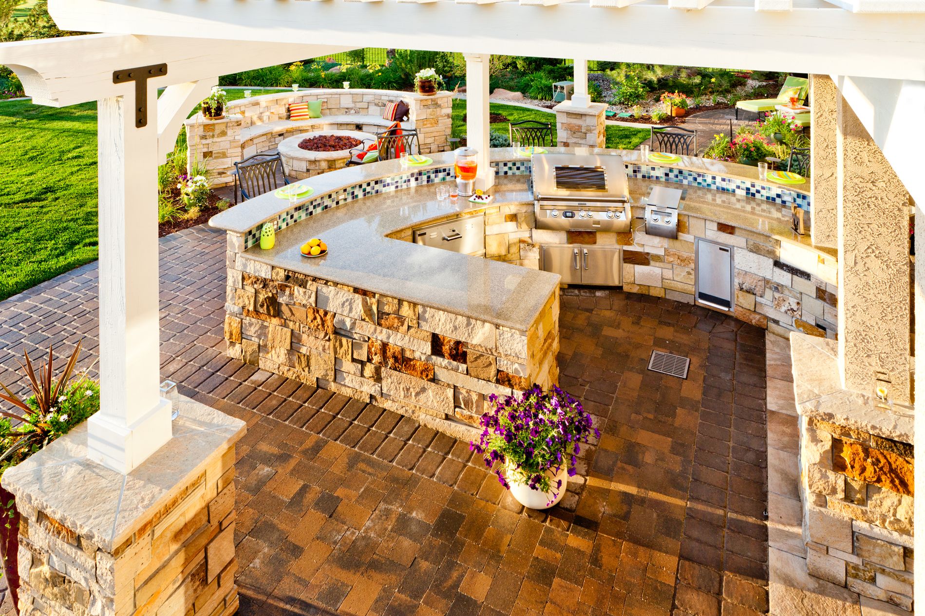 Outdoor Kitchen with White Pergola and Paver Patio