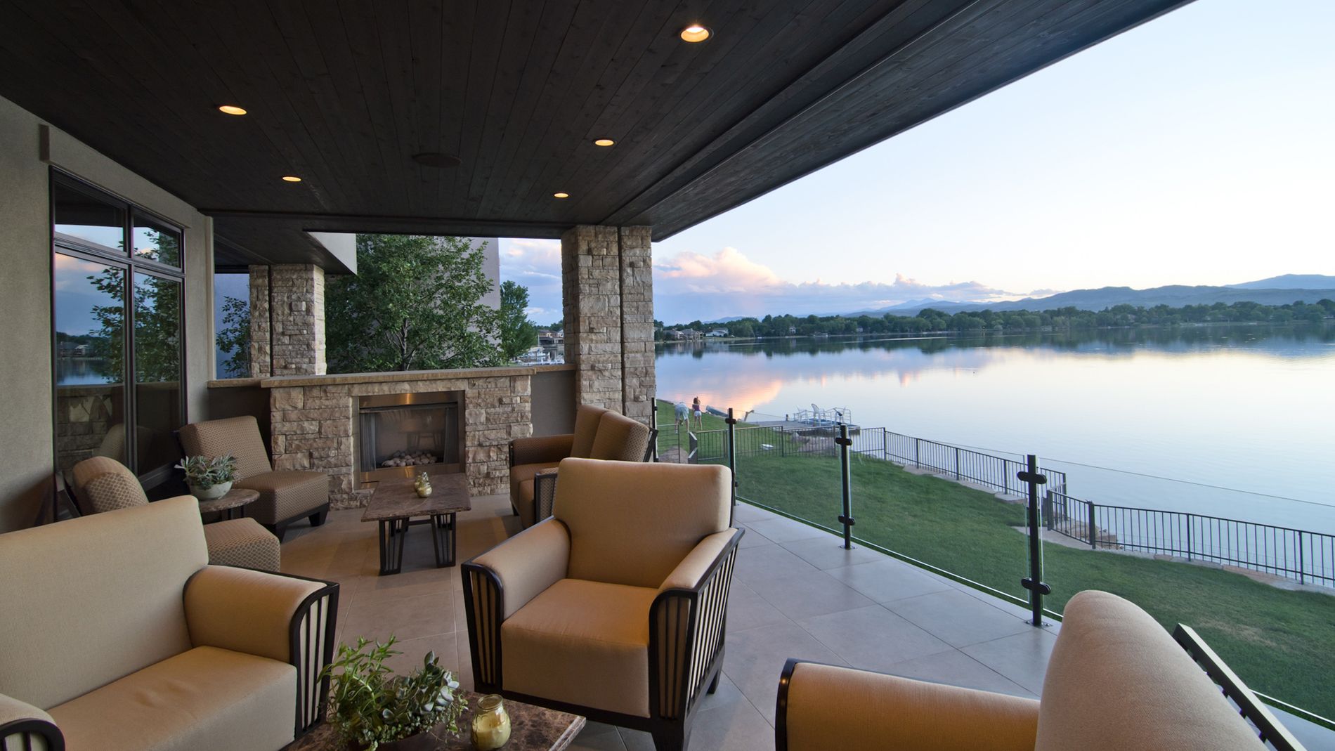 Outdoor living deck with landscape and lake views