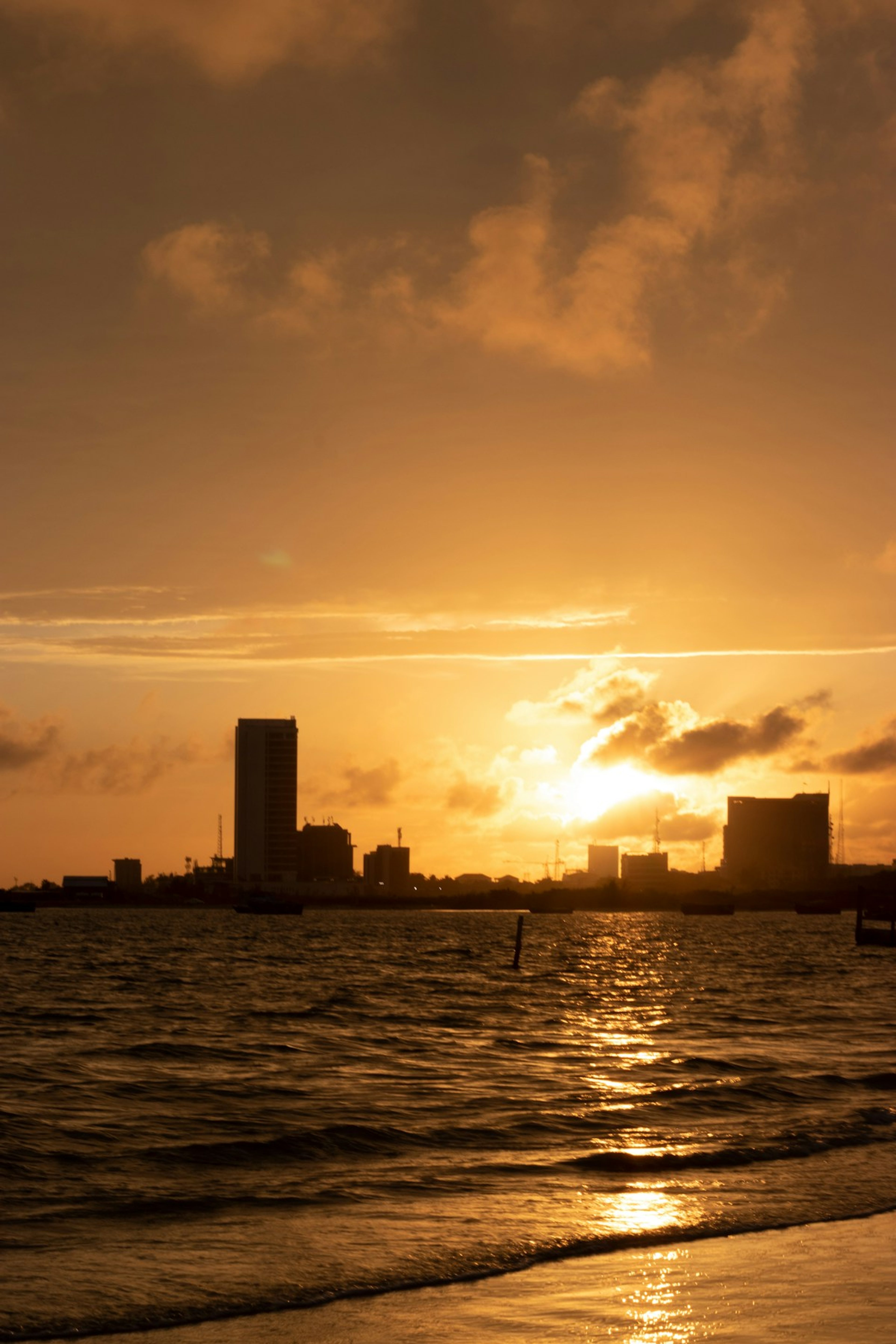 The Lagos skyline across the water at sunset.