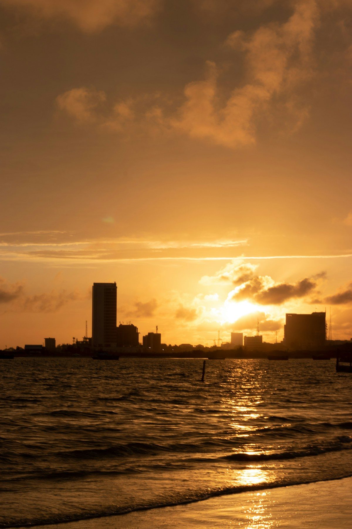 The Lagos skyline across the water at sunset.