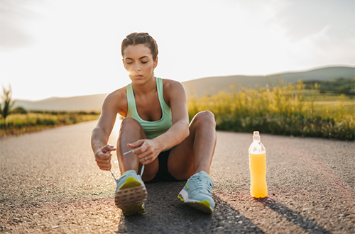 woman with sports drink getting ready for run | stim free pre workout