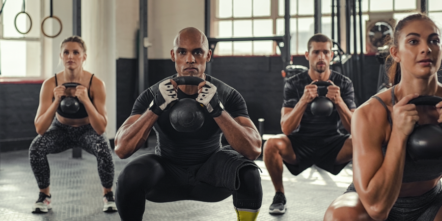 group fitness class with kettlebells | time under tension