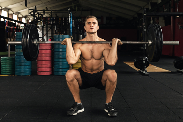 man front squatting with barbell | front squat vs back squat