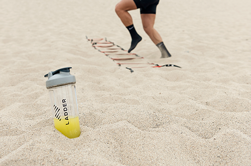 pre workout bottle in sand | does pre workout break a fast