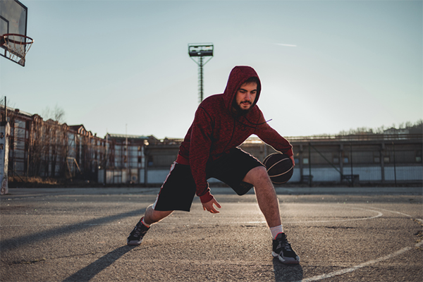 man dribbling basketball through legs | lateral quickness