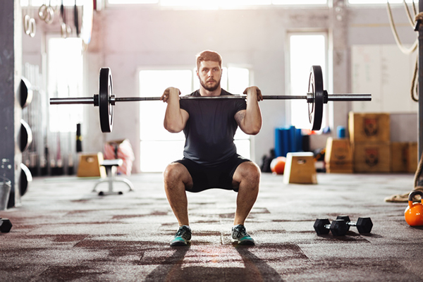 man doing front squat | time under tension