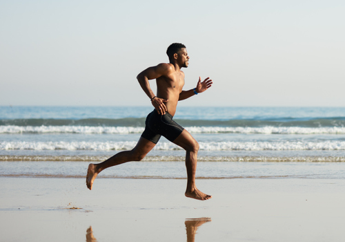 man running on beach | barefoot training