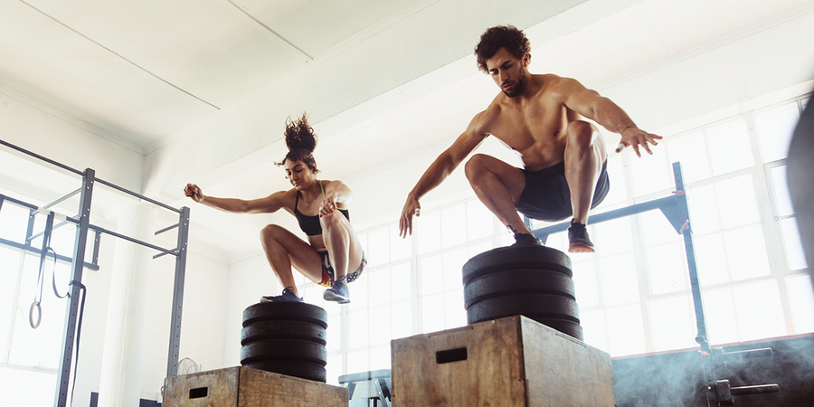 man and woman doing box jumps | how to jump higher