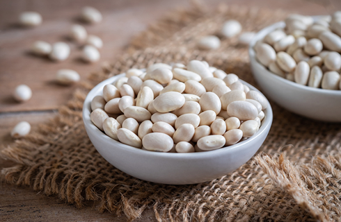 white beans in bowl | foods that help with muscle cramps