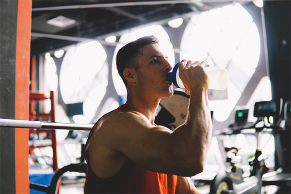 man drinking protein shake | creatine and protein
