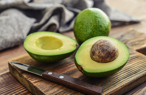 avocados on cutting board | foods that help with muscle cramps