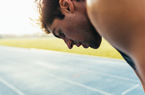 close up of tired runner looking down