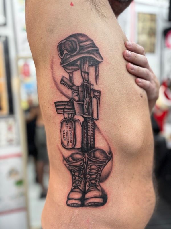 Black and grey realistic military tribute tattoo on torso