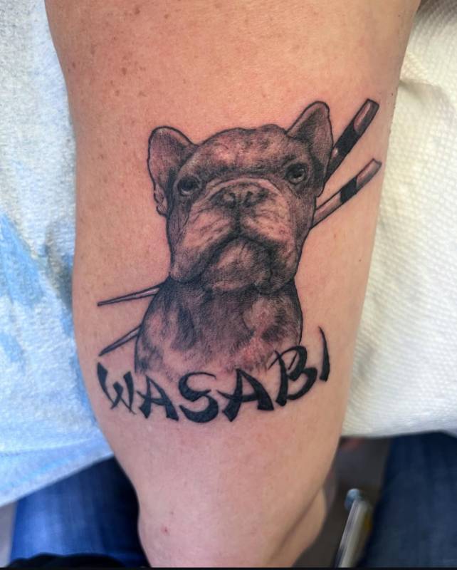 Black and grey realistic bulldog with Wasabi script on upper arm