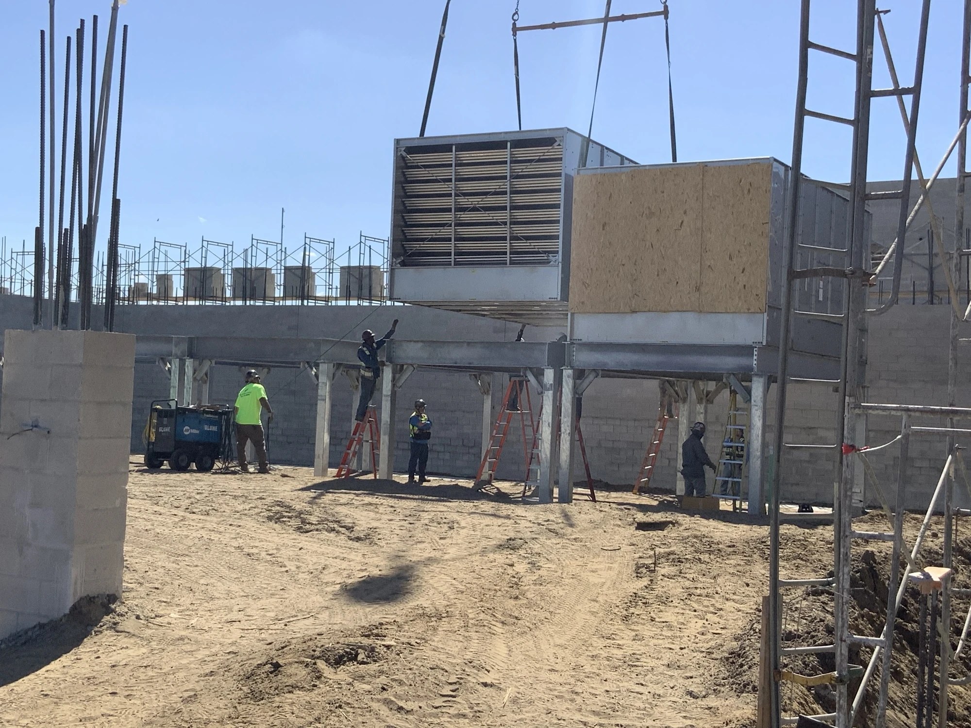 Mechanical equipment positioned at a construction site with installation personnel nearby at BayCare Manatee