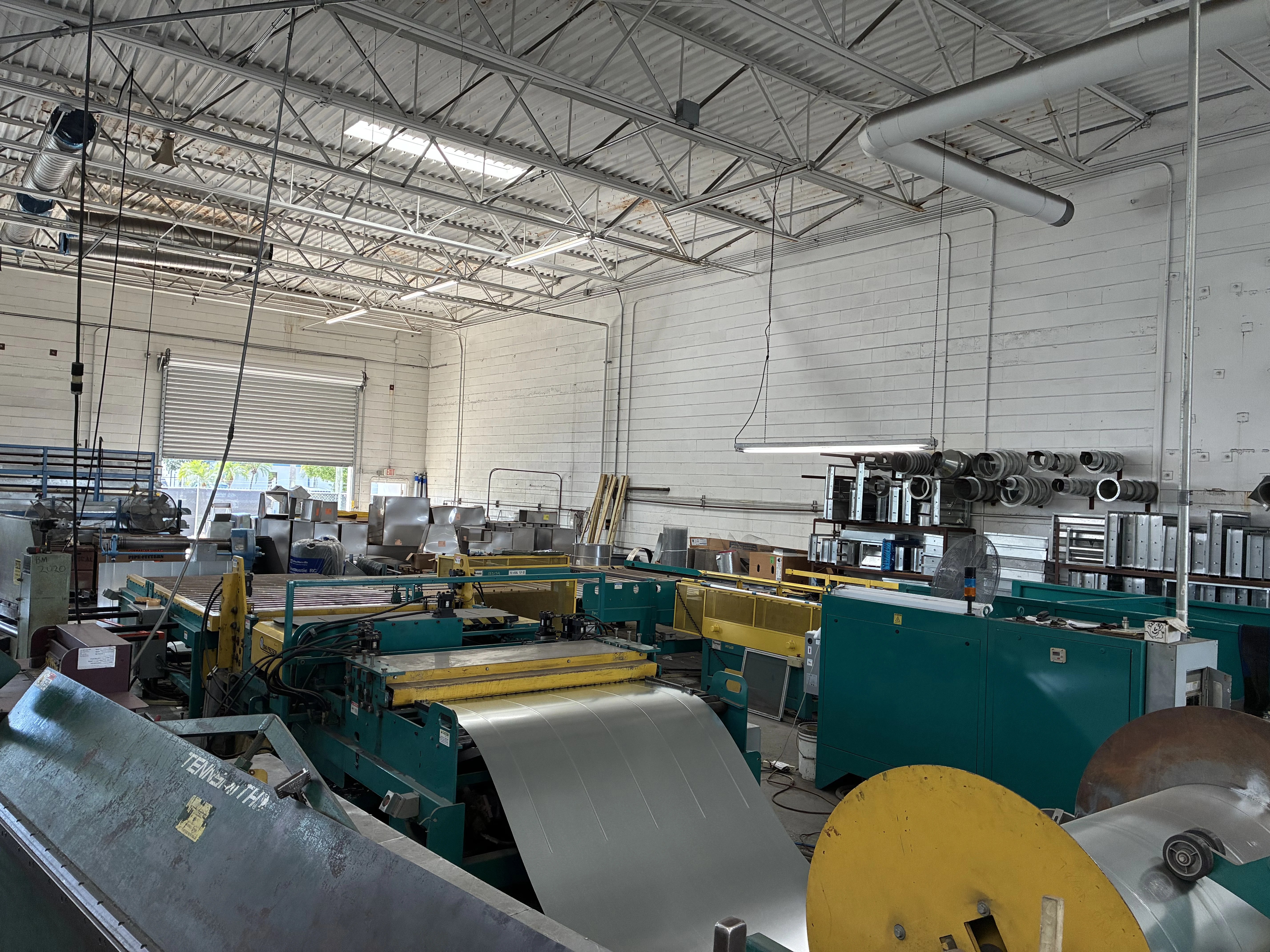 A coil of sheet steel feeding the coil line in the fabrication shop