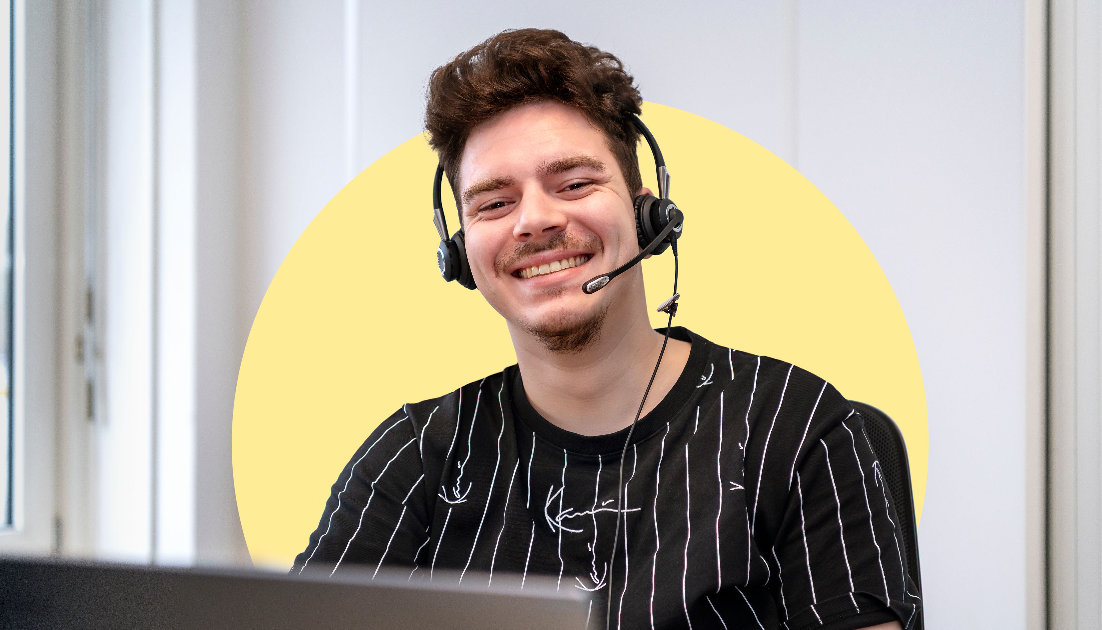 Jongen met headset lacht in camera