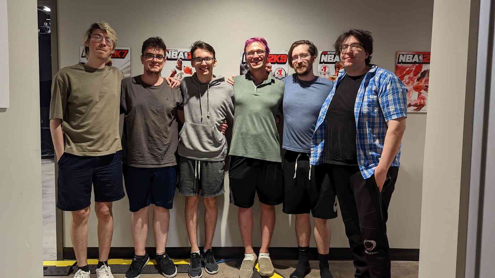 The roster for 4 Zoomers stand together back stage at an event