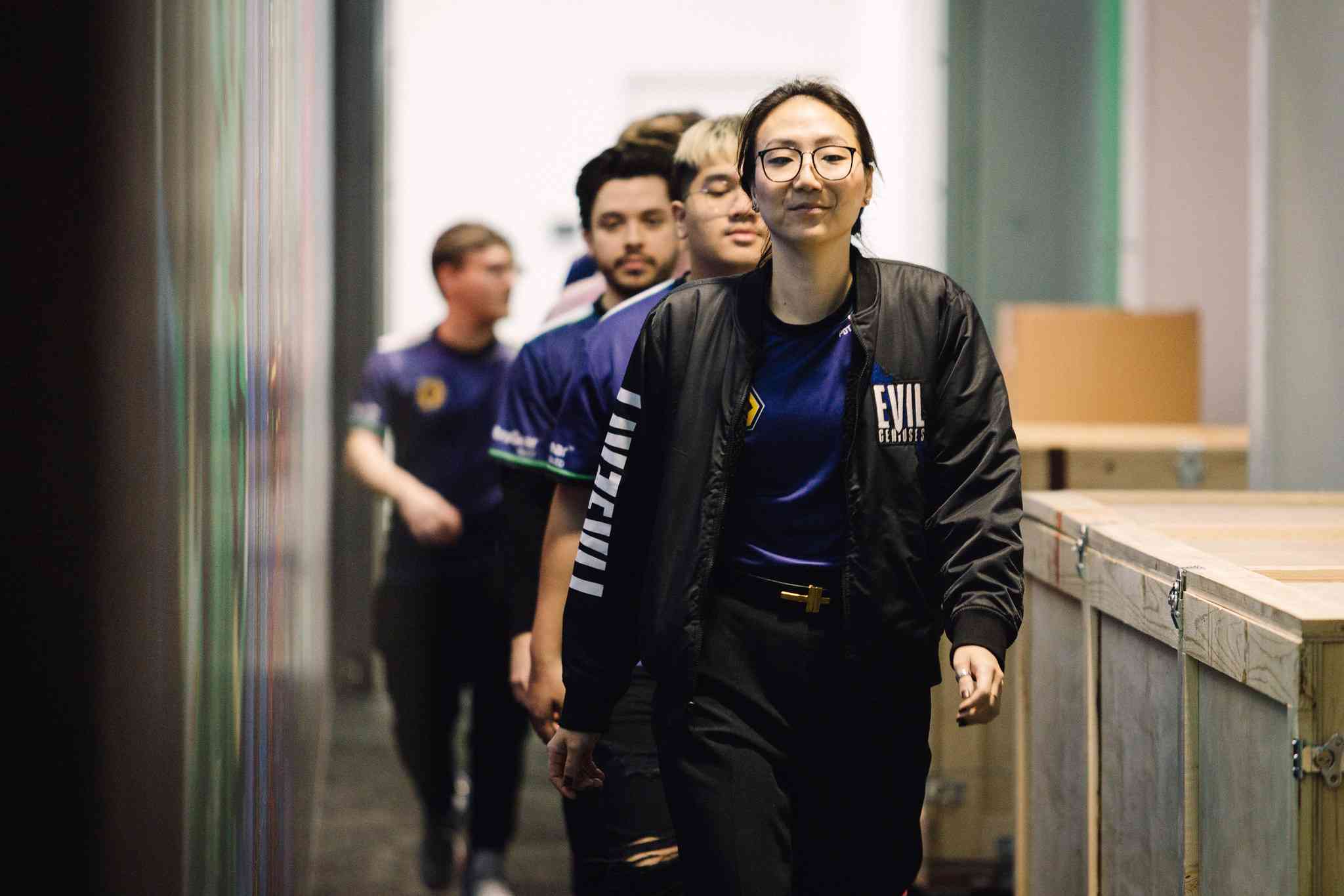 EG coach Christine "potter" Chi walking with the team backstage before facing MIBR in Week 7 of the 2023 VCT Americas League season (Credit: Marv Watson/Riot Games)