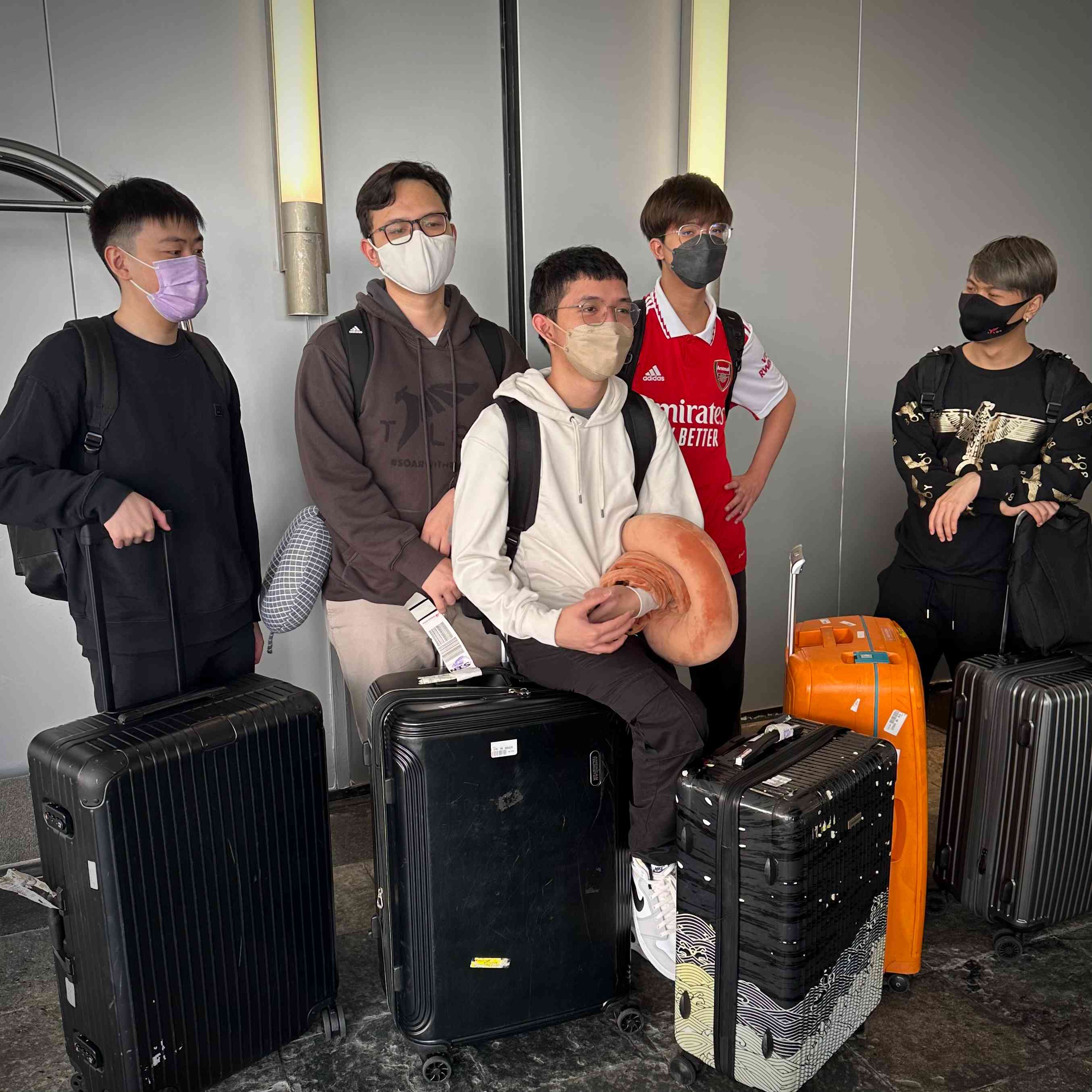 The roster for Talon Esports, with suitcases packed arrive at Singapore International airport for TI 11