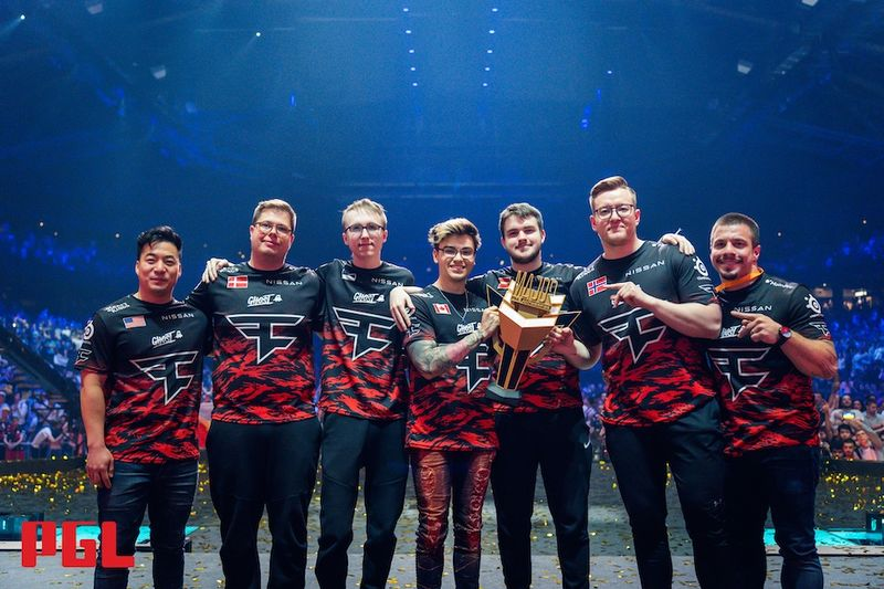 The roster for FaZe clan stand together holding the trophy after winning the PGL Major Antwerp 2022