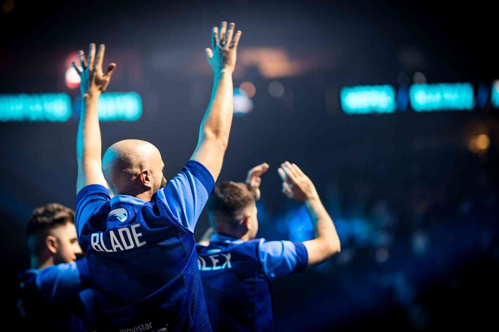 Movistar Riders coach Galder "bladE" Barcena lifts his hands up toward the crowd as the team take the stage at IEM Cologne 2022