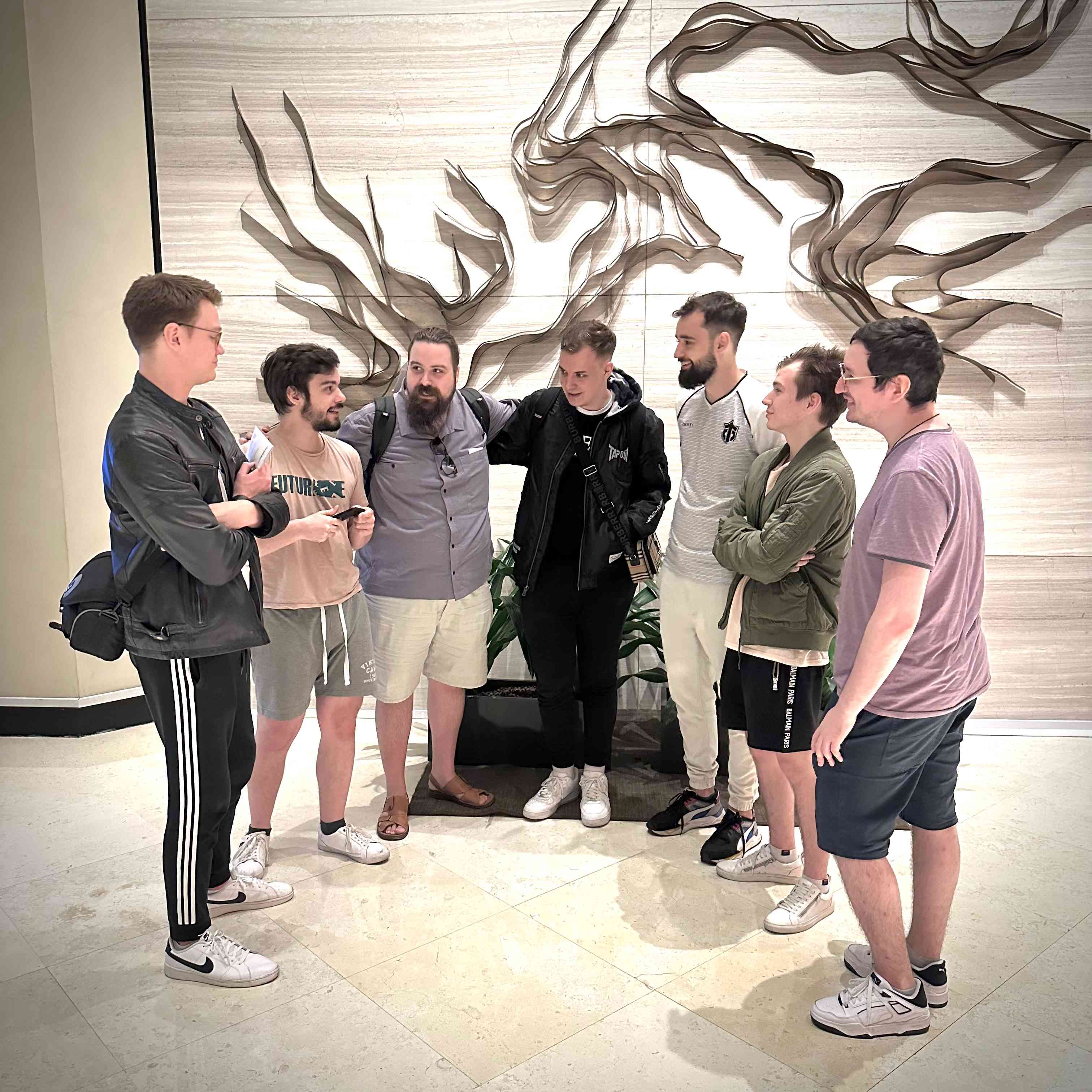The roster for Entity huddle together to talk shop at Singapore International airport after arriving for TI 11