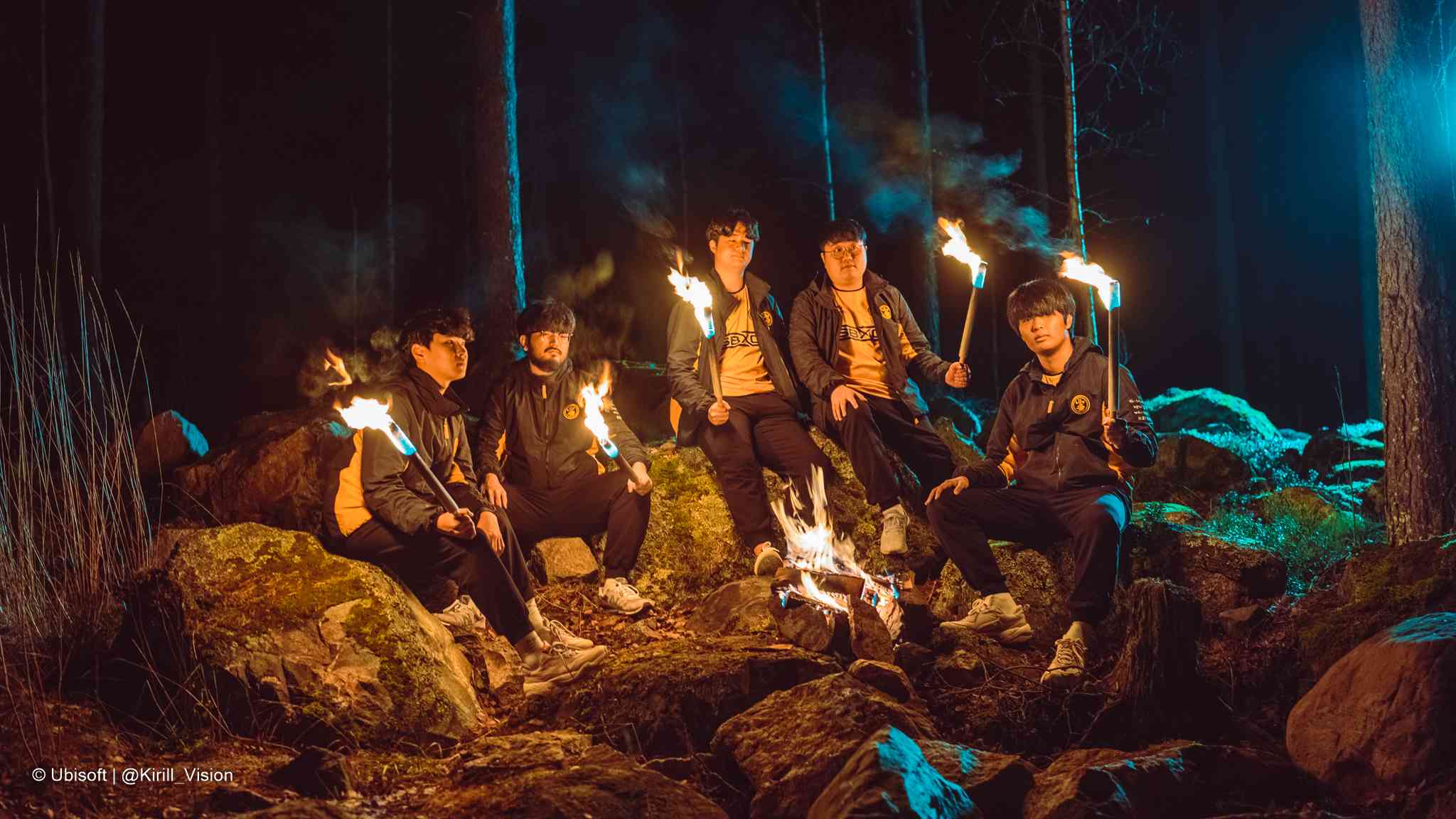 The Rainbow Six roster for SANDBOX sit in the woods at night, holding flaming torches