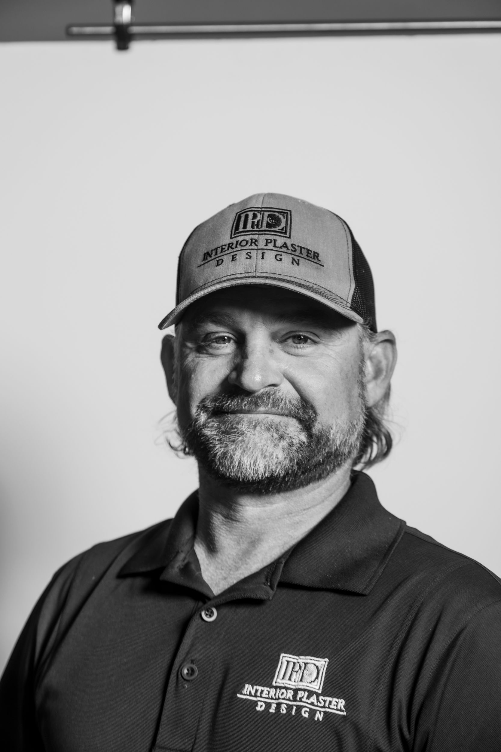 man with a hat smiling at the camera