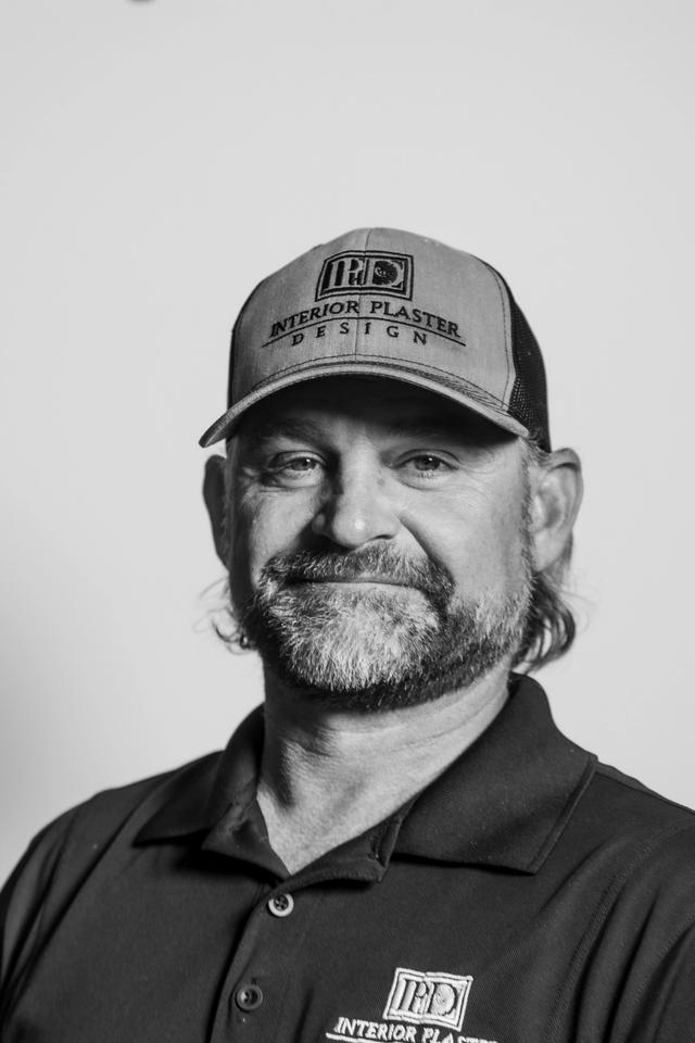 man with a hat smiling at the camera