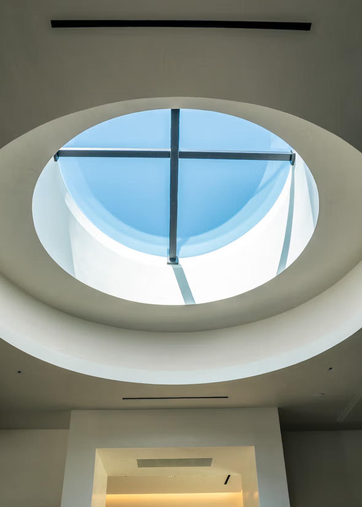 A color photo of a skylight detail of a building that shows the sky