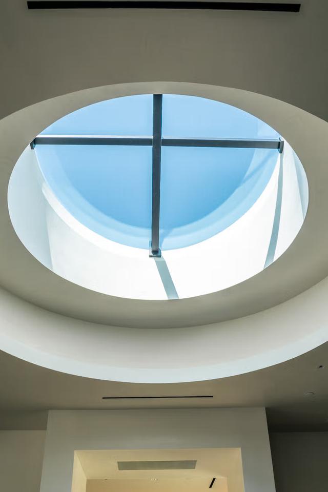 A color photo of a skylight detail of a building that shows the sky