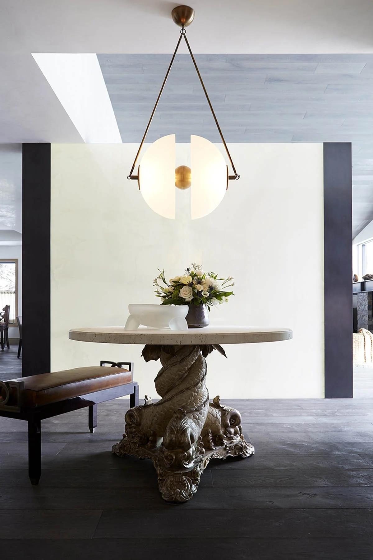 photo of a hanging lamp over a magnificent circular table