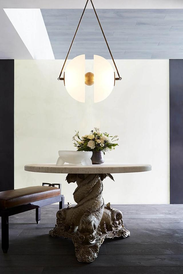 photo of a hanging lamp over a magnificent circular table