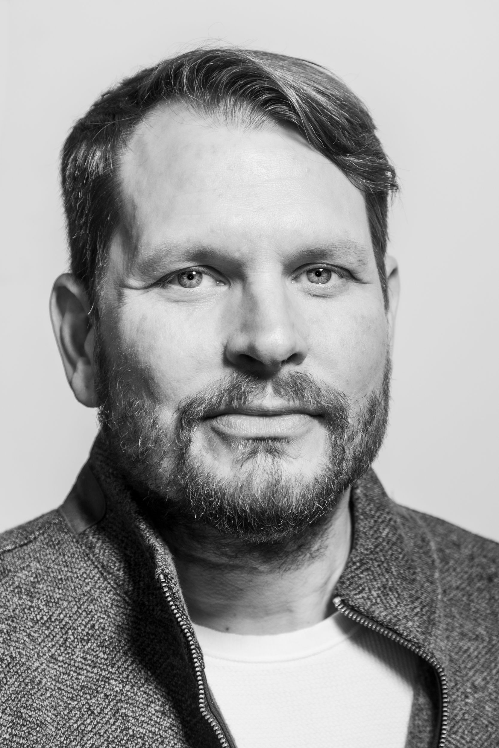 Black and white photograph of Andrew Gibson, looking into the camera lens