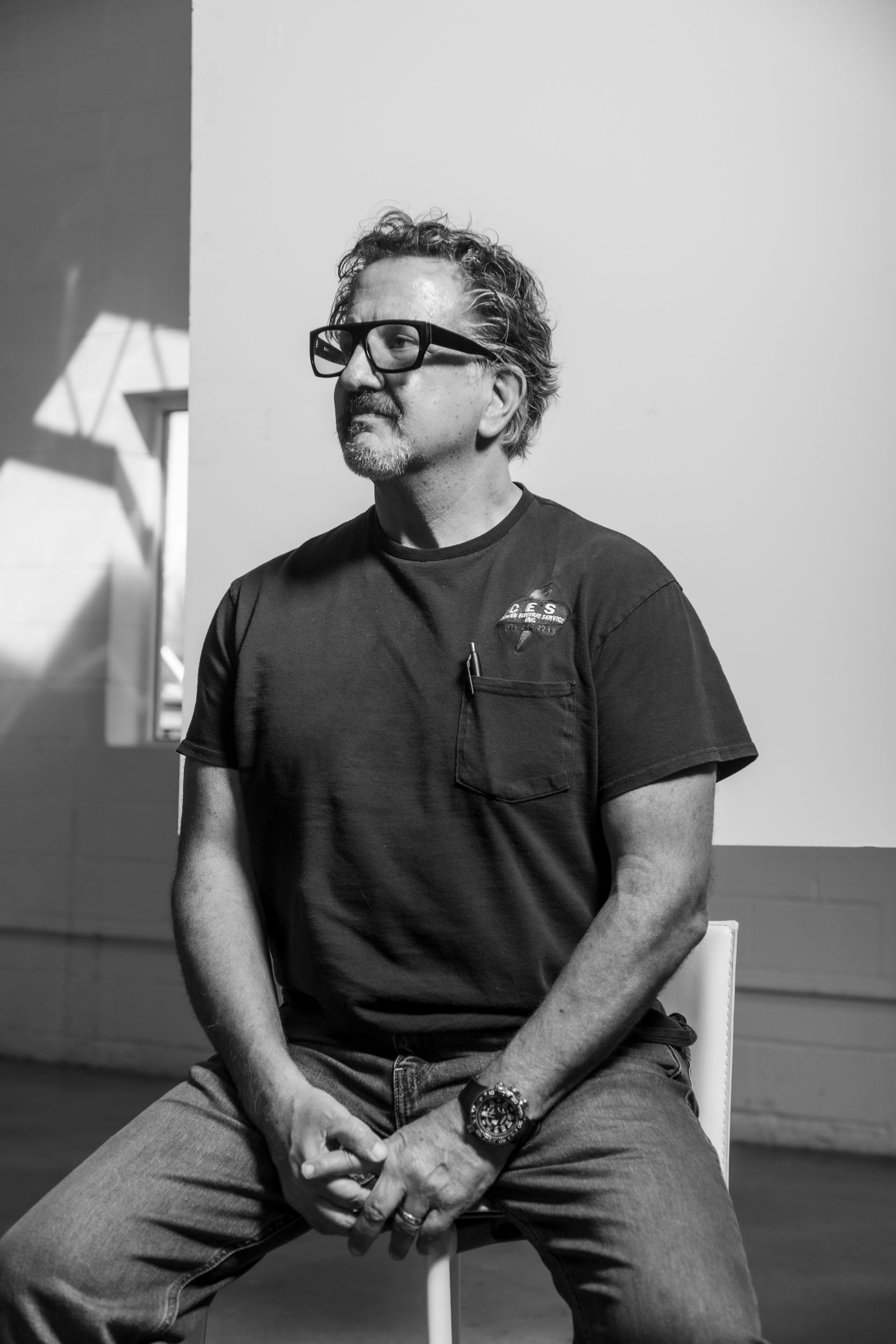 man sitting down with glasses on