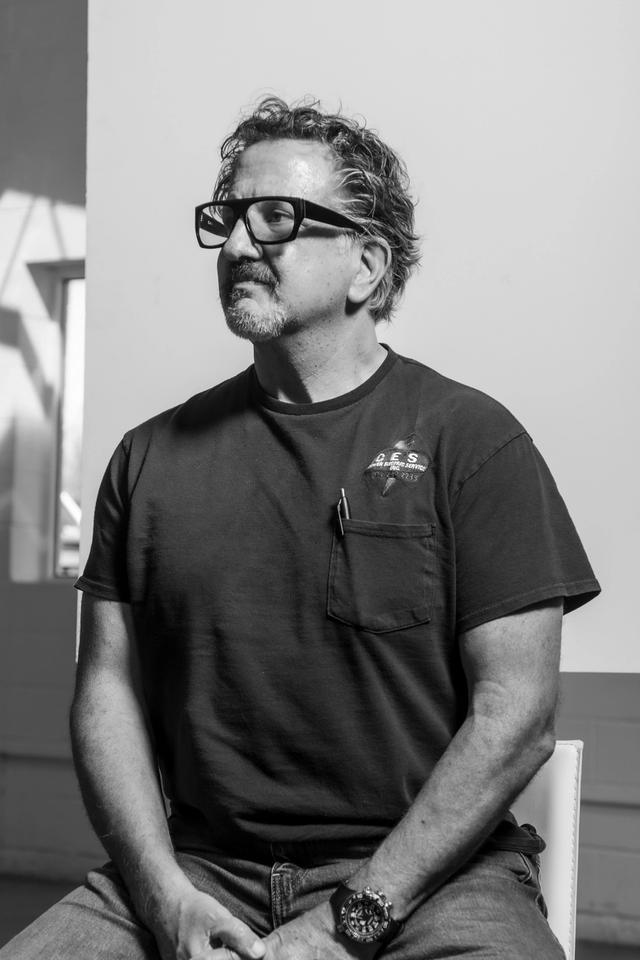 man sitting down with glasses on