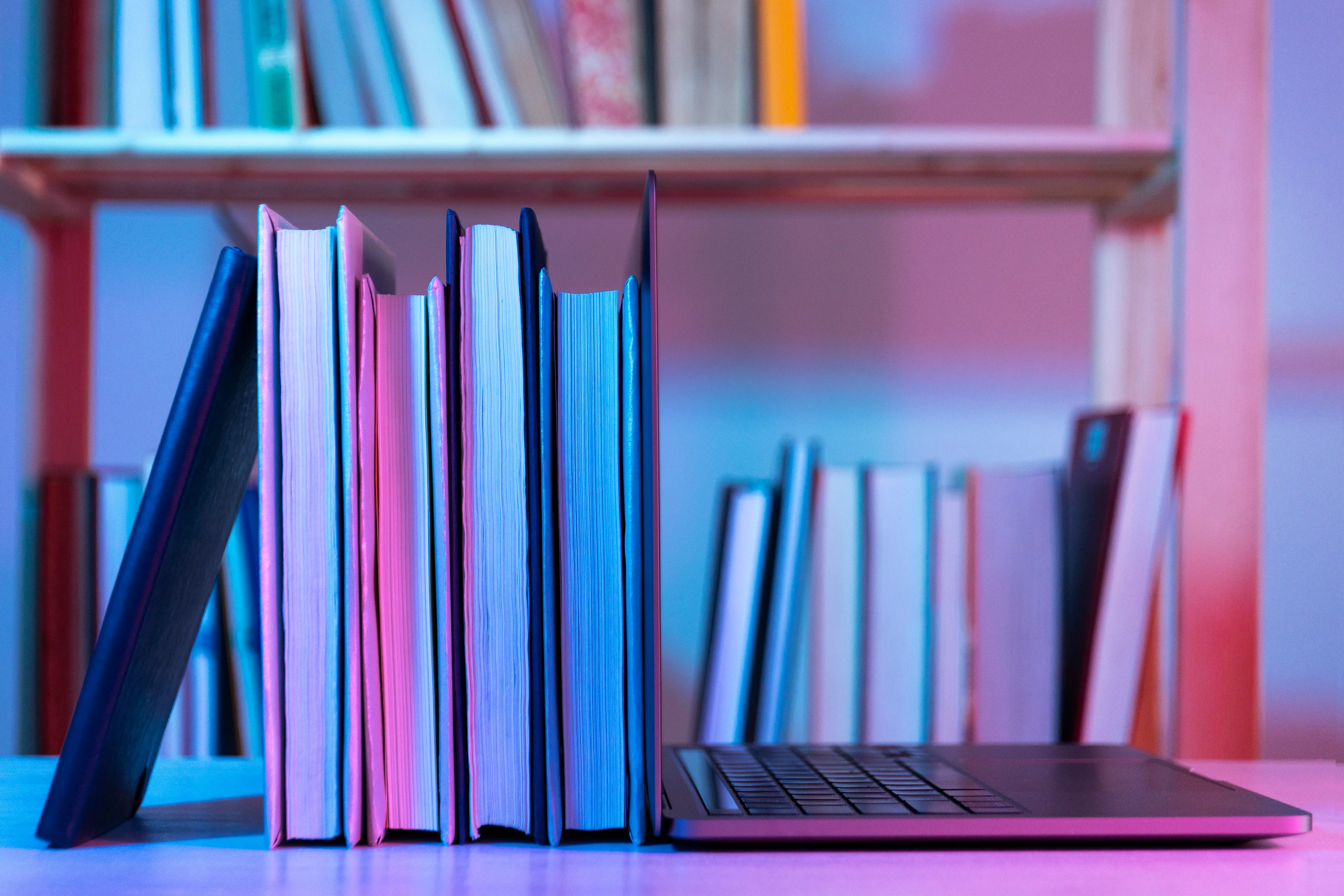 books leaning against laptop