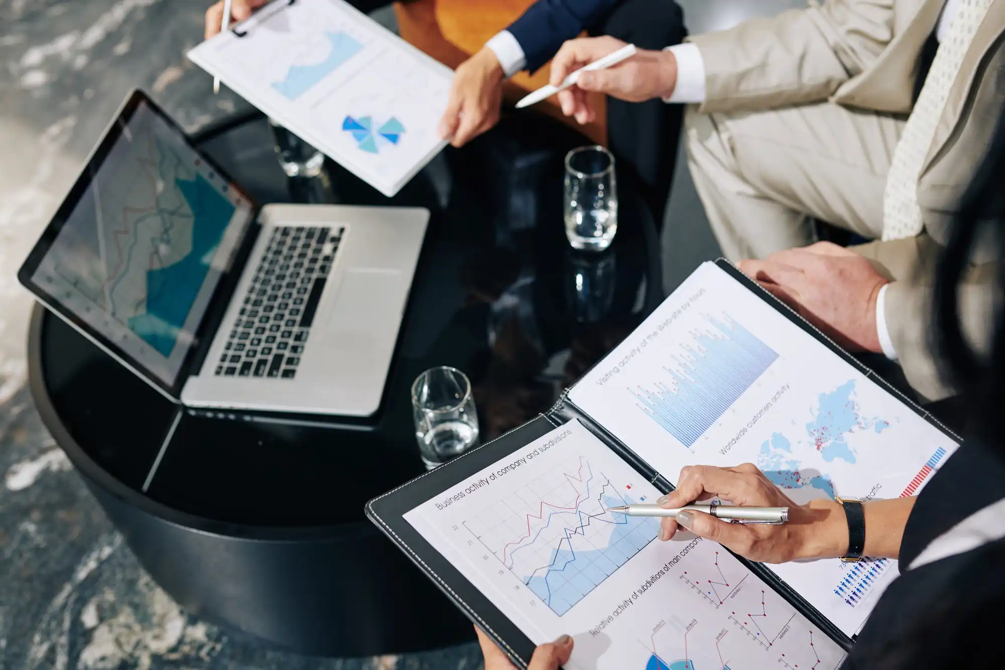 professional colleagues holding business-related reports in hand