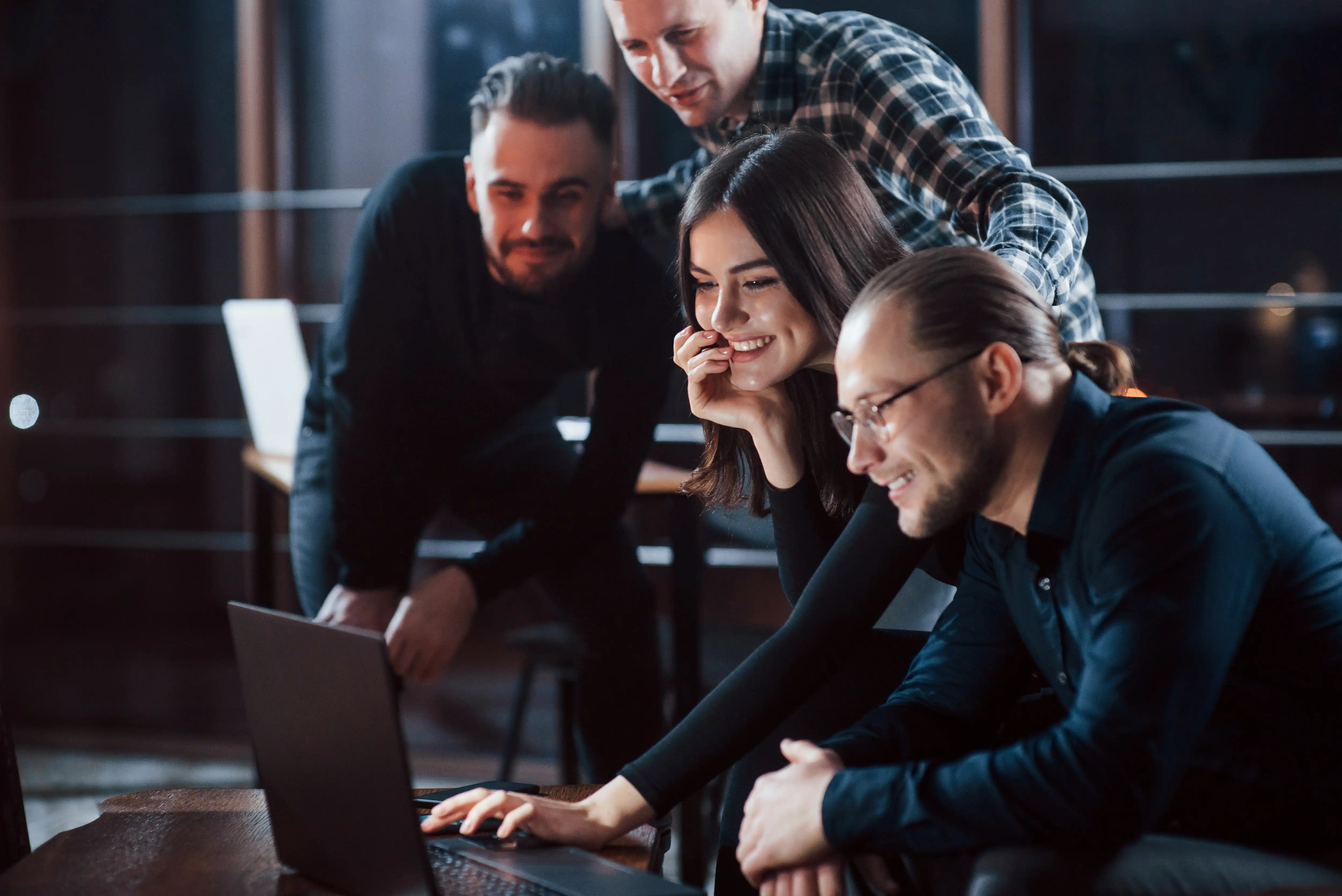 a group of people looking at a computer