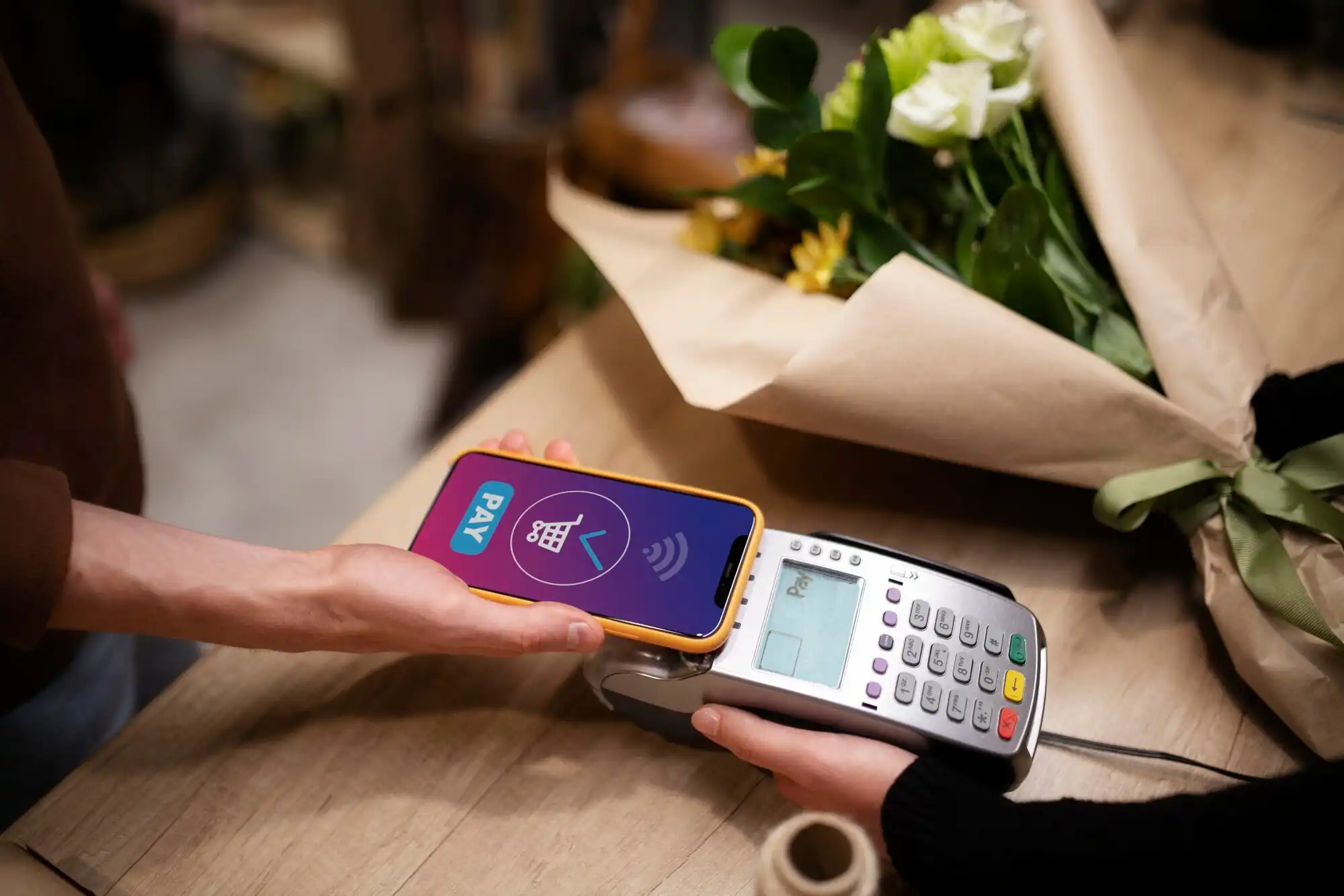 Client paying for a beautiful bouquet of flowers with mobile app on phone