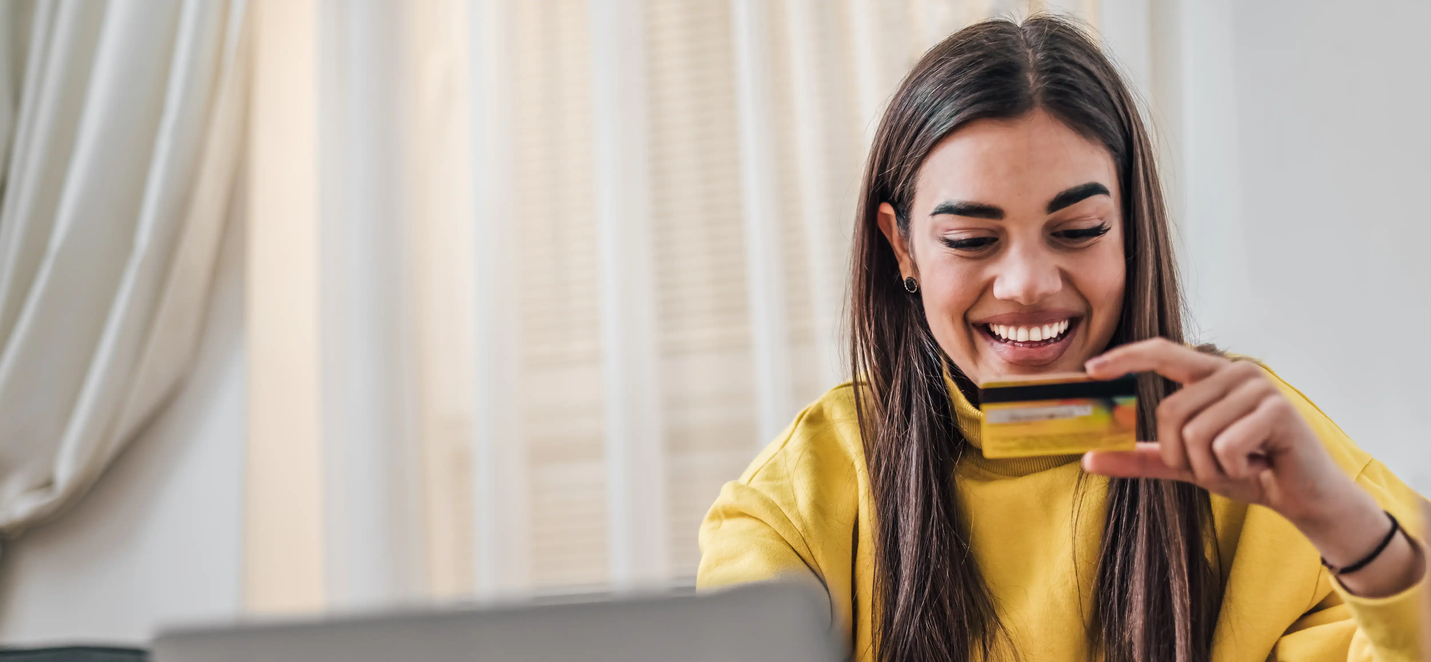 woman putting in card information on her laptop