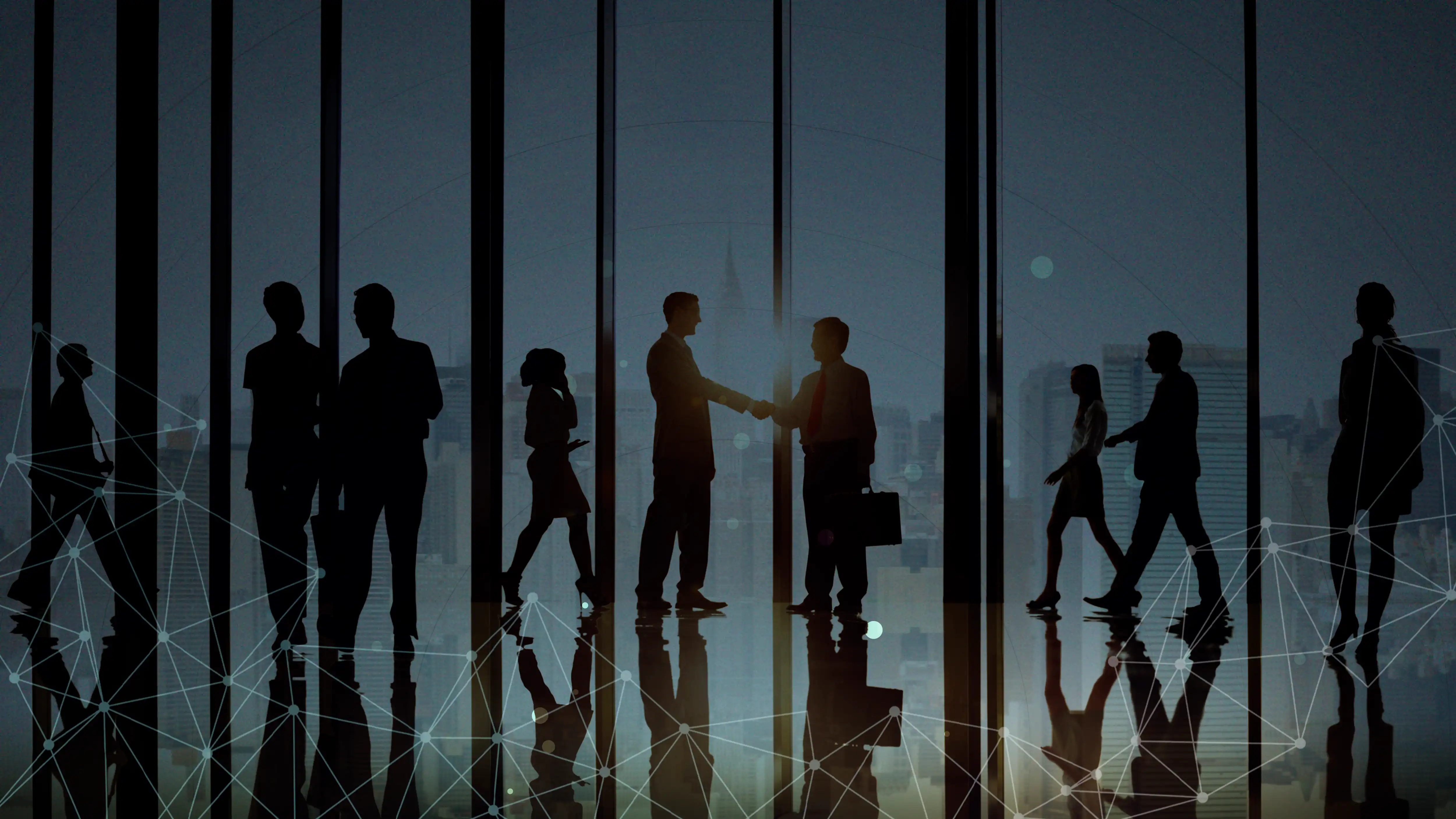 silhouettes of people walking together and shaking hands