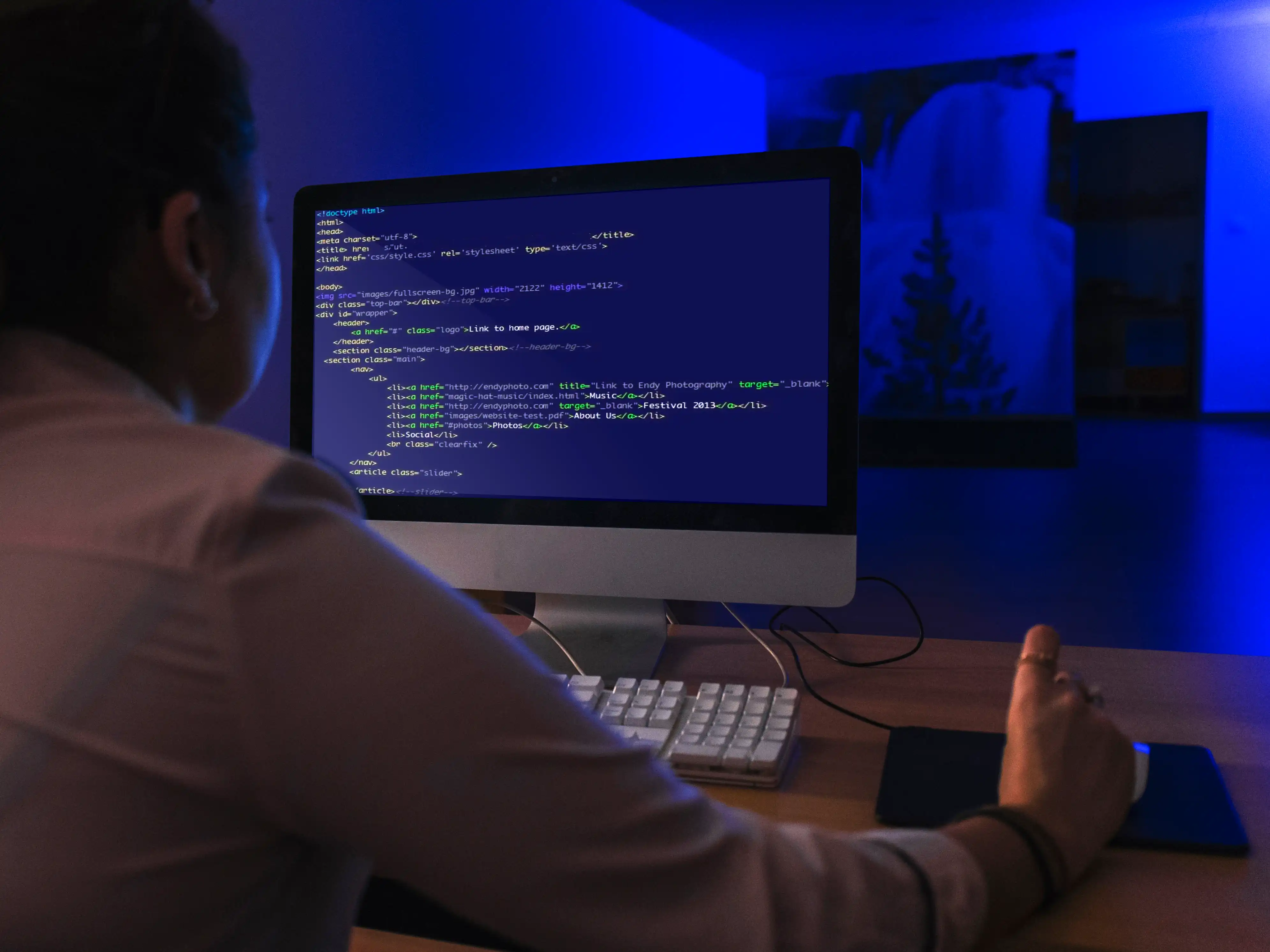 Man coding on desktop