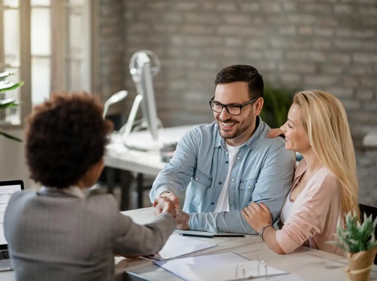 couple handshaking with advisor 