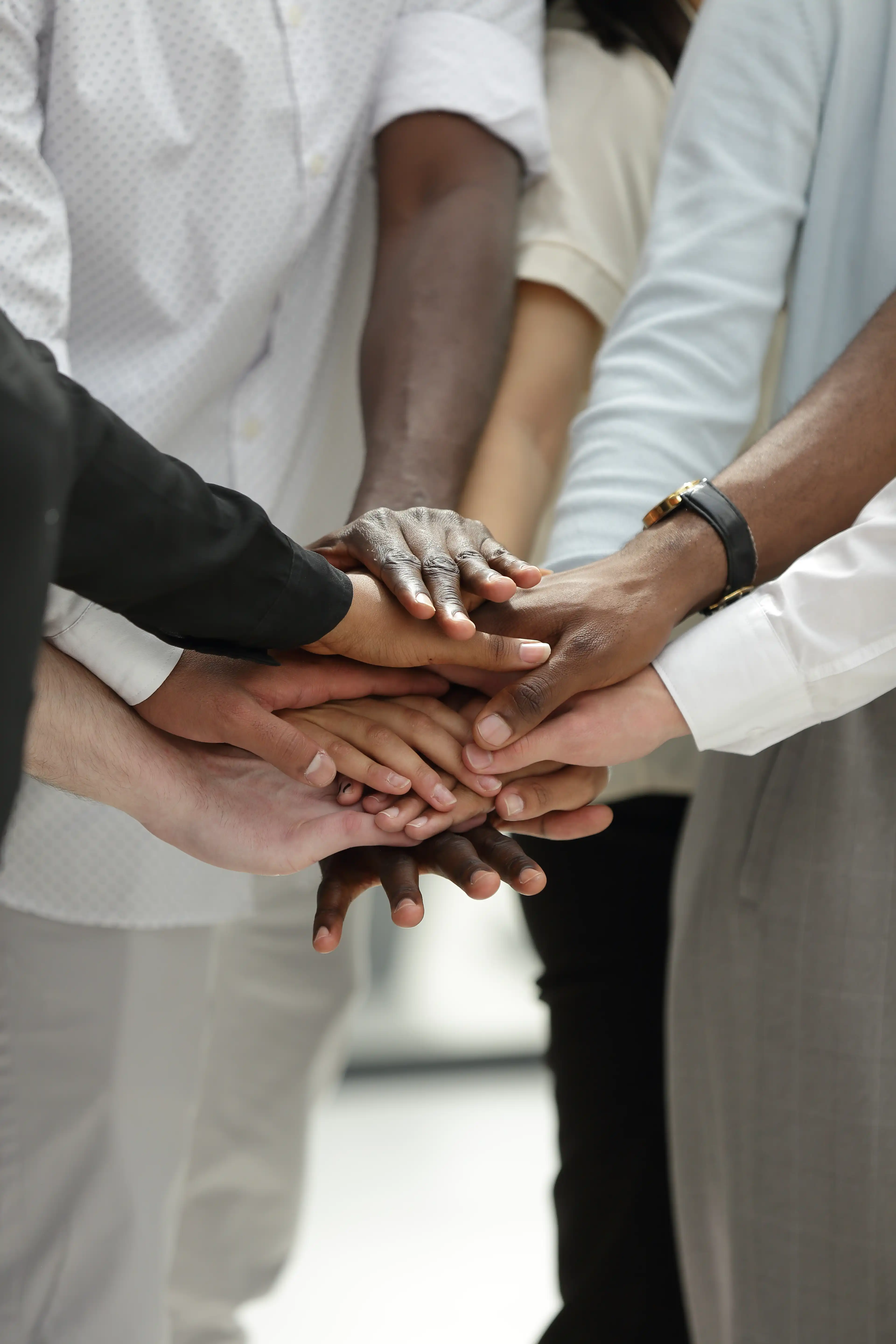 work colleagues stacking their hands on top of each other