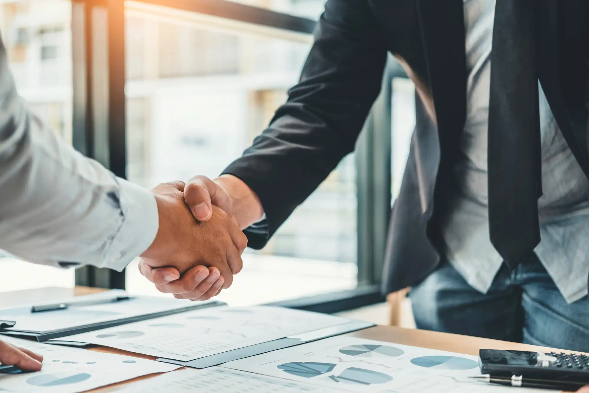 two men in professional, business apparel shaking hands