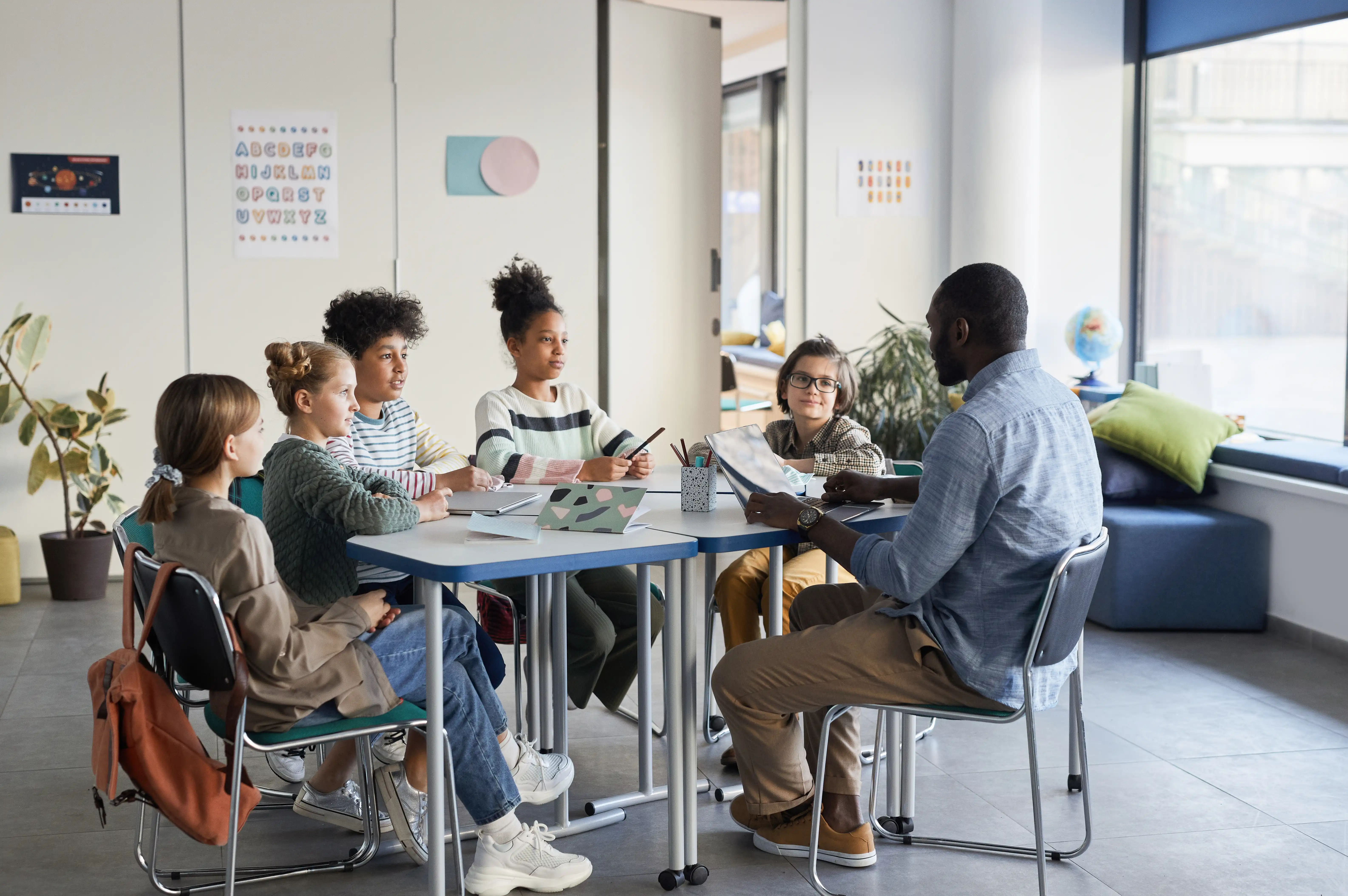man teaching children 