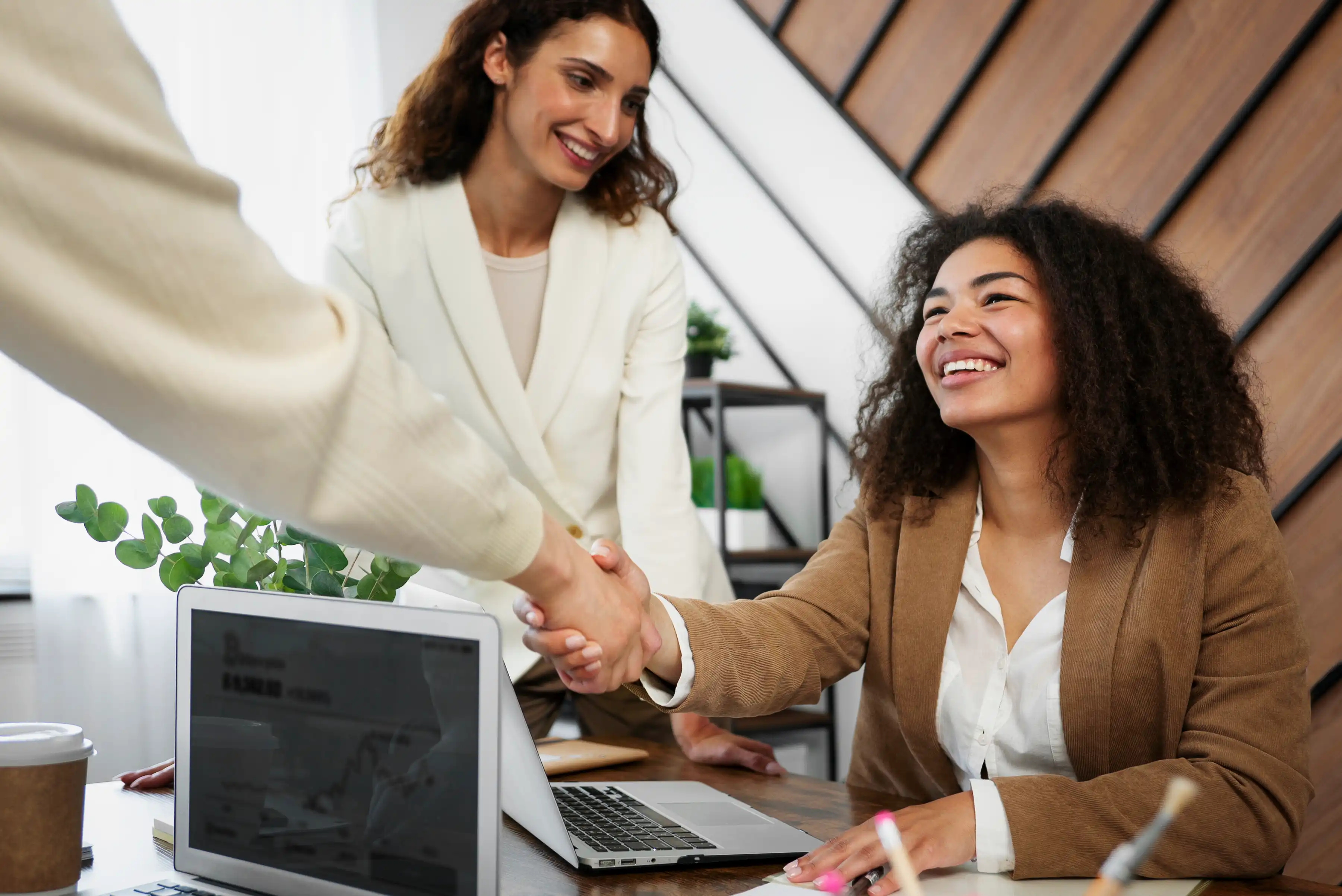 people in office shaking hands