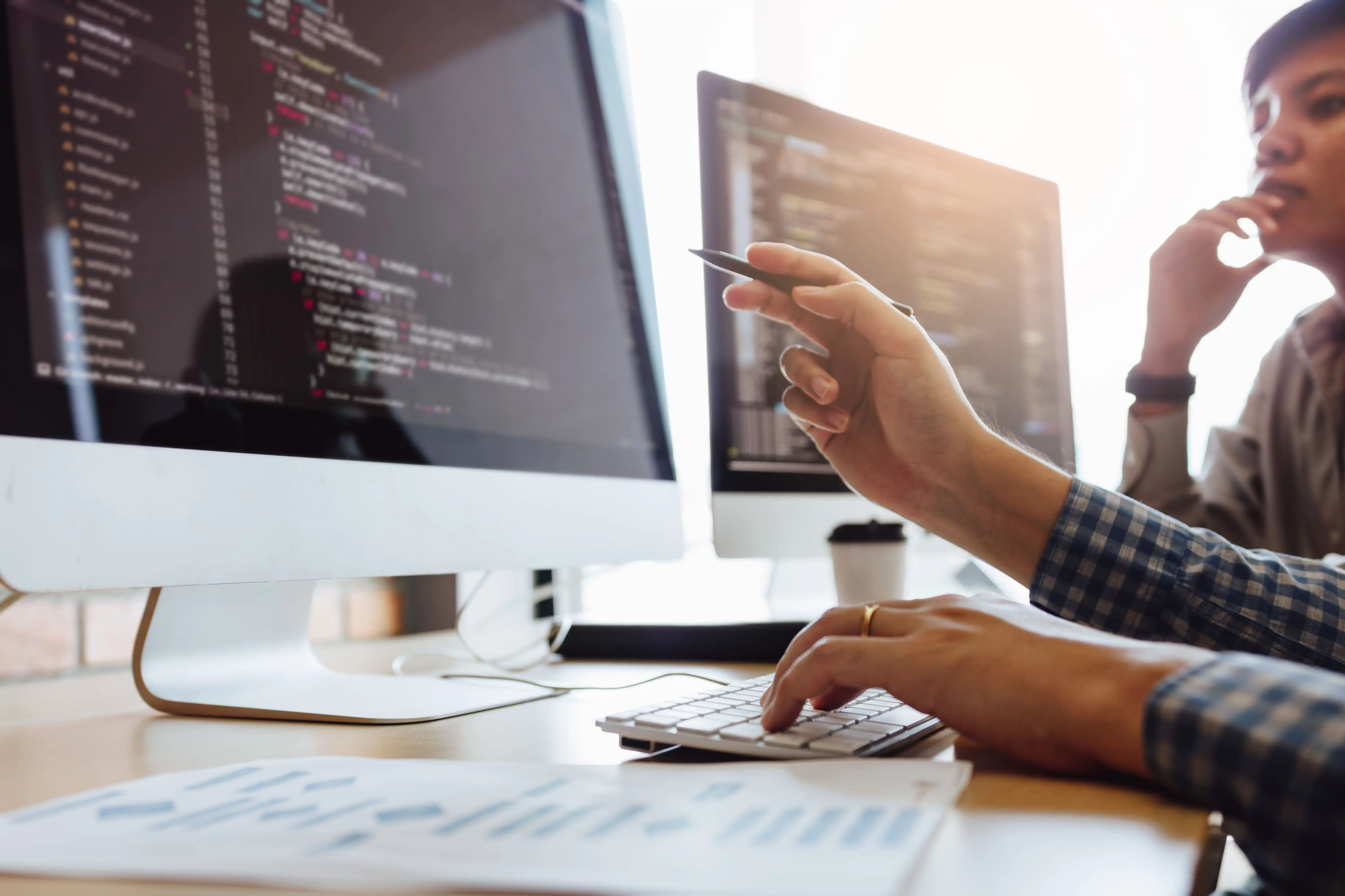 Engineers looking at a screen